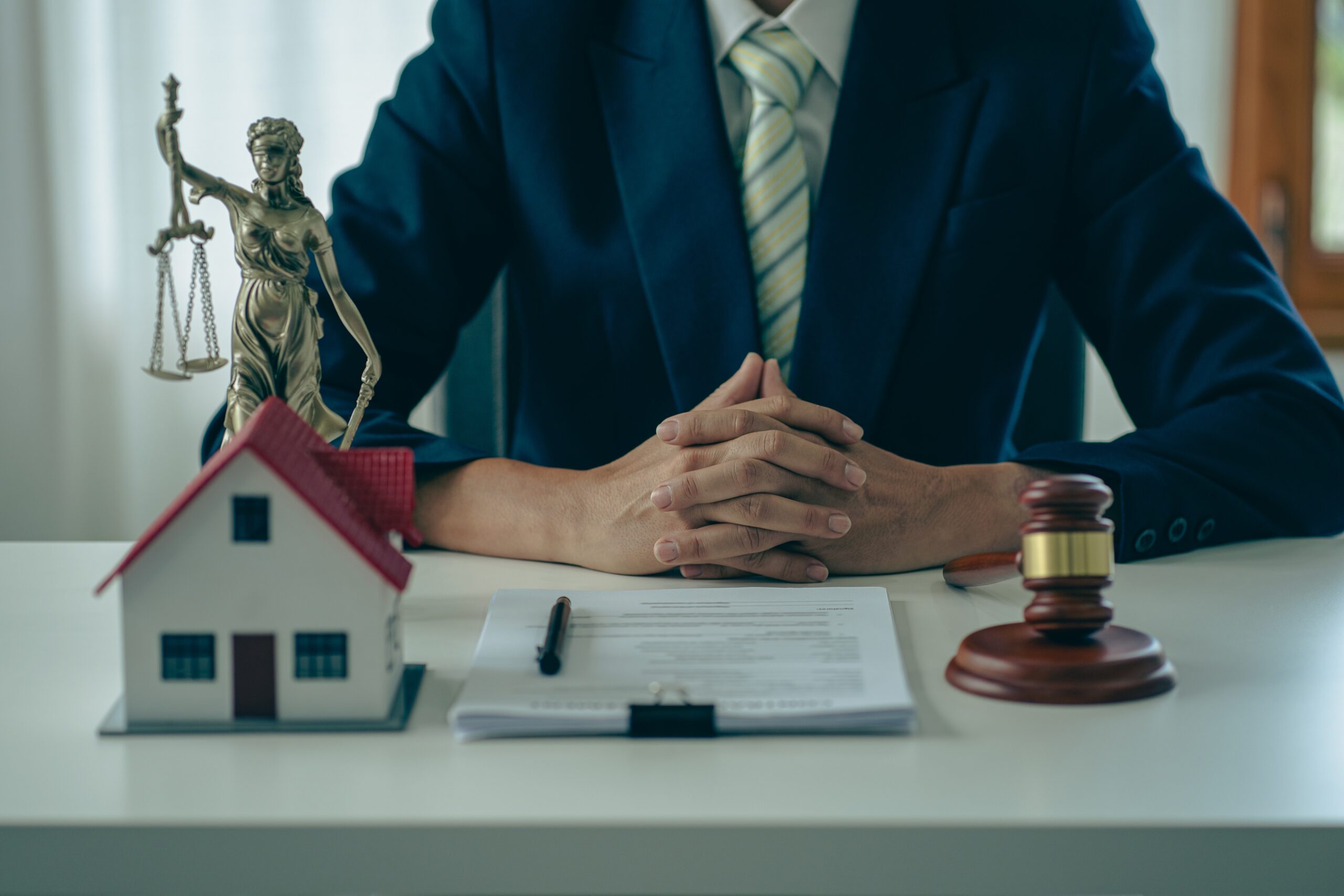 Bankruptcy and mortgage defense lawyer in North Carolina sits at a desk with legal documents, foreclosure alternatives.